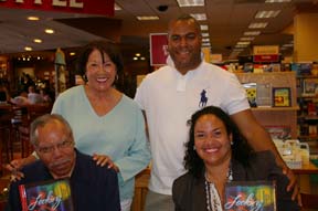 Dr. Bob Bailey and wife Anna, take a break from signing books to pose with daughter Kimberly Bailey-Tureaud and son-in-law Charles Tureaud.
